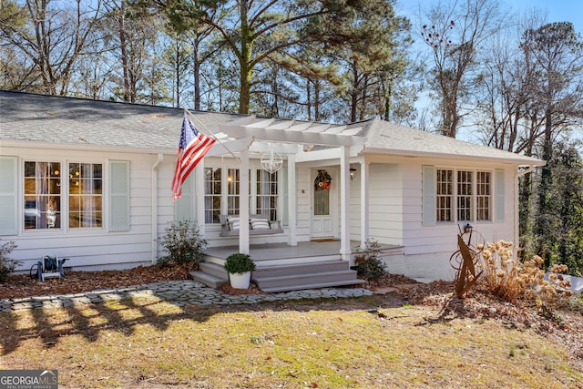 ranch-style house featuring a front yard and a pergola