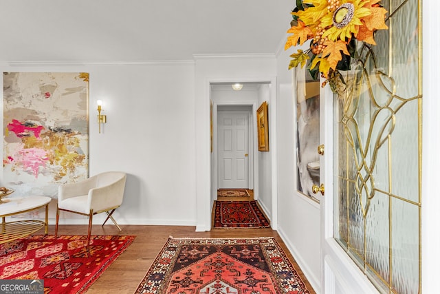 corridor featuring ornamental molding and wood-type flooring