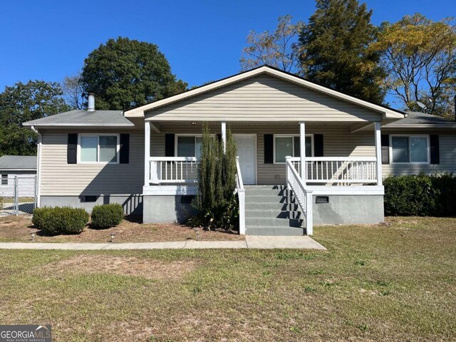 bungalow-style house with a front lawn and covered porch