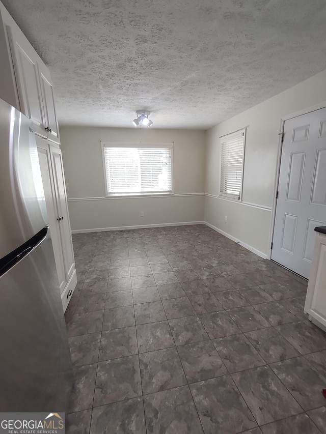 spare room with a textured ceiling