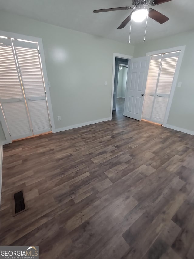 unfurnished bedroom with dark hardwood / wood-style floors, ceiling fan, and a closet