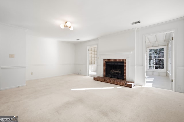 unfurnished living room with light carpet, a brick fireplace, and ornamental molding