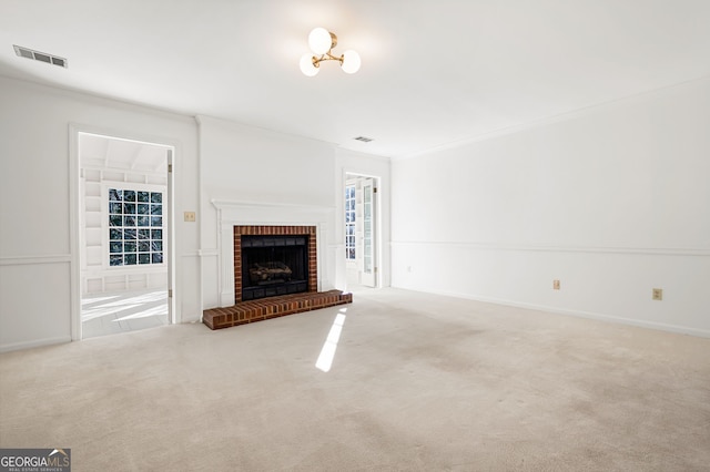 unfurnished living room featuring a fireplace, carpet flooring, and ornamental molding