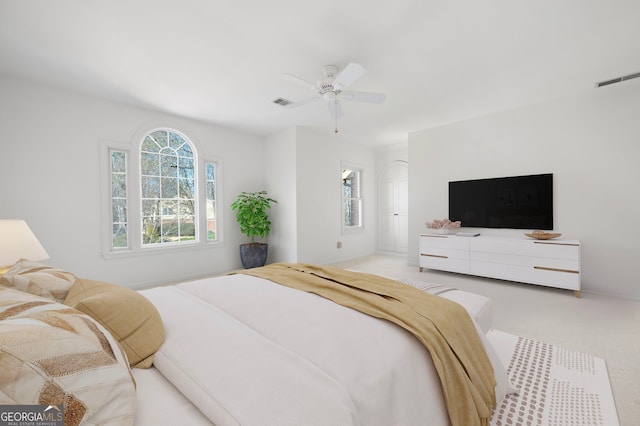 bedroom featuring light carpet and ceiling fan