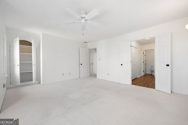 unfurnished bedroom featuring light carpet and ceiling fan