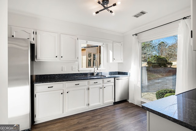 kitchen featuring white cabinets, dark hardwood / wood-style floors, and stainless steel appliances