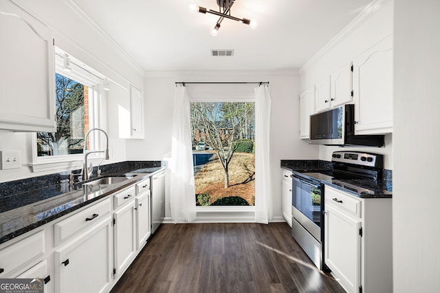 kitchen with sink, white cabinets, dark stone countertops, and appliances with stainless steel finishes