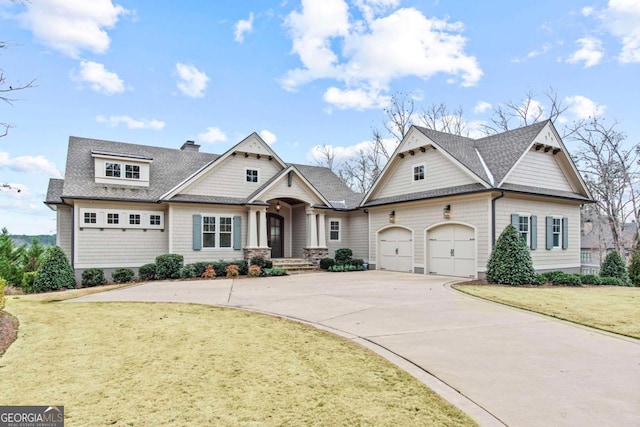 view of front of home featuring a garage and a front yard