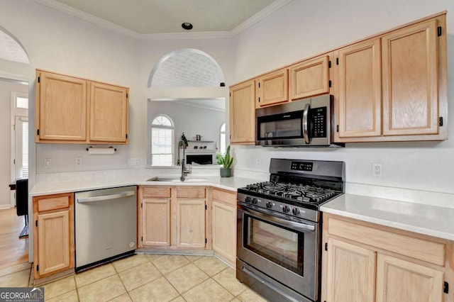 kitchen featuring sink, light brown cabinets, stainless steel appliances, and light tile patterned flooring