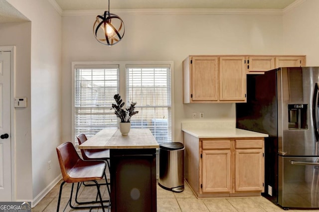 kitchen featuring decorative light fixtures, stainless steel refrigerator with ice dispenser, light tile patterned flooring, crown molding, and light brown cabinetry