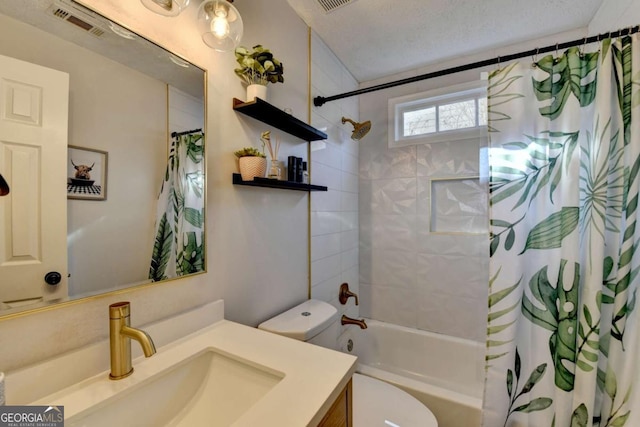 full bathroom featuring toilet, a textured ceiling, vanity, and shower / bath combo with shower curtain