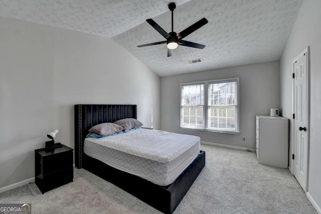 carpeted bedroom with ceiling fan, a textured ceiling, and lofted ceiling