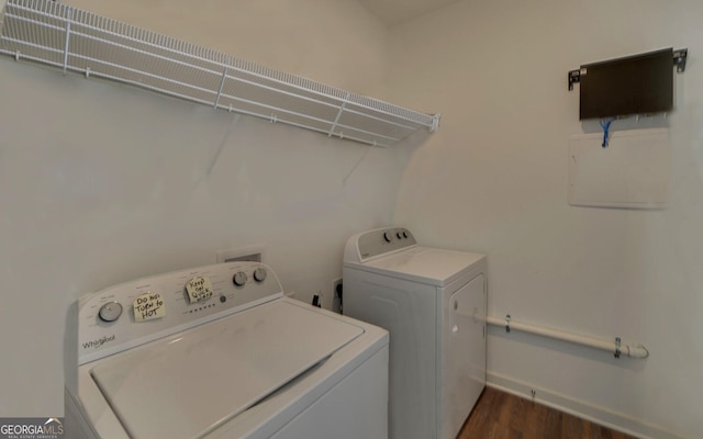 laundry area with dark hardwood / wood-style floors and separate washer and dryer