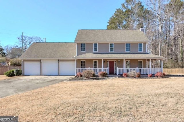 view of front of house featuring a front lawn, a porch, and a garage