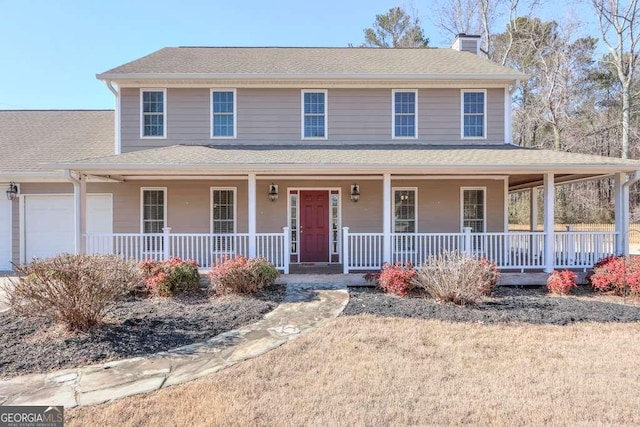 farmhouse inspired home featuring a garage and a porch