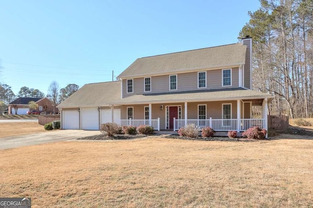 view of front of home featuring a front yard, a garage, and a porch