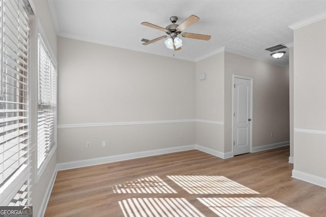 unfurnished room with ceiling fan, ornamental molding, and light hardwood / wood-style floors