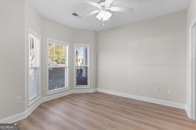 spare room with light hardwood / wood-style floors and ceiling fan