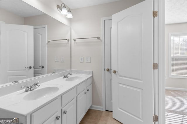 bathroom with tile patterned floors and vanity