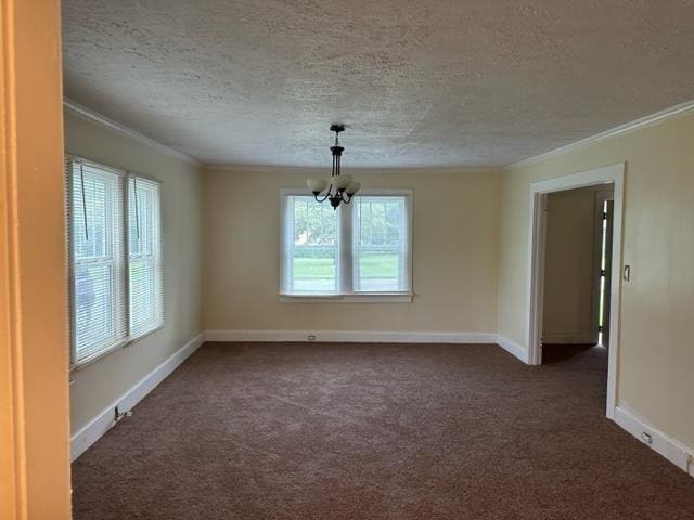 carpeted empty room featuring a textured ceiling, an inviting chandelier, and ornamental molding