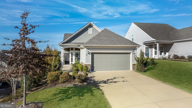 view of front of property with a front yard and a garage