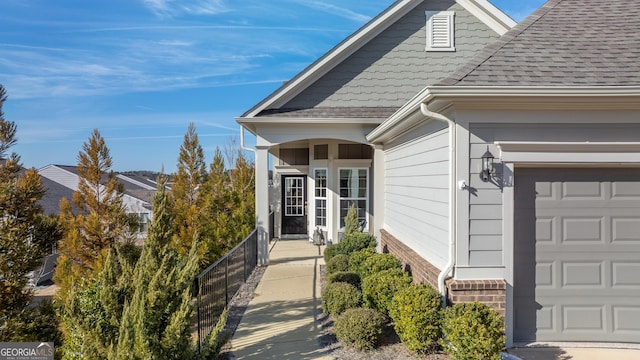 doorway to property with a garage