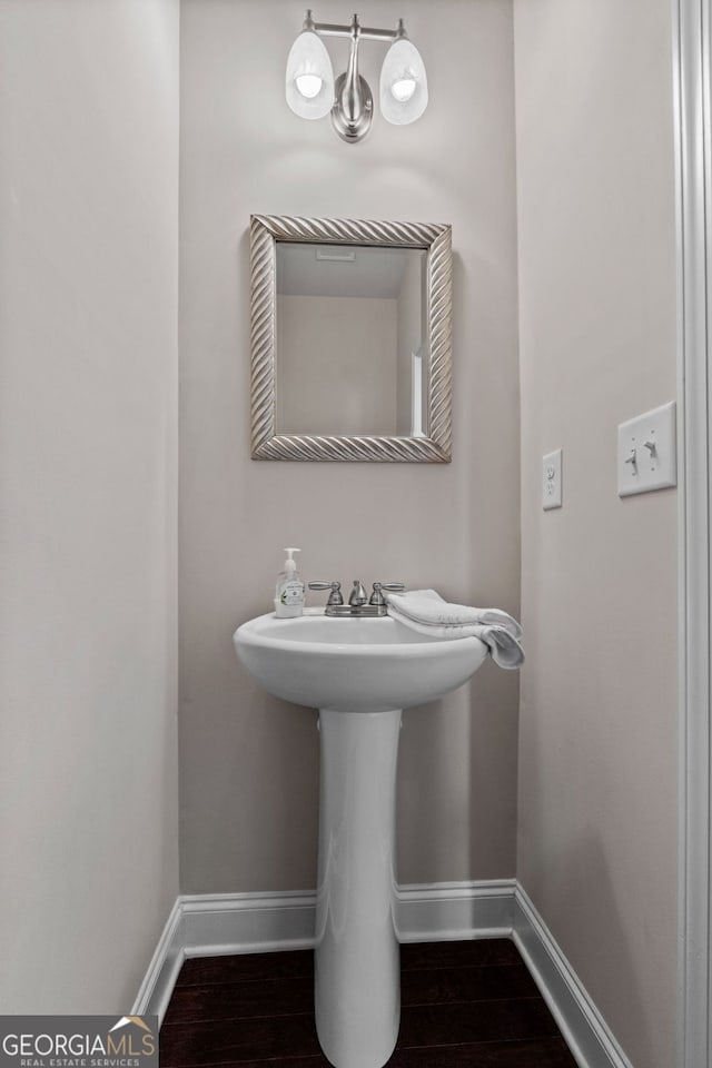 bathroom featuring baseboards and wood finished floors