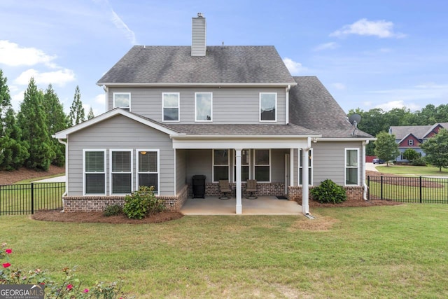 back of property with a patio area and a lawn