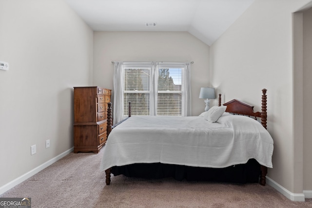 carpeted bedroom featuring vaulted ceiling, visible vents, and baseboards