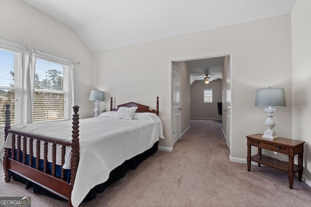 bedroom with lofted ceiling, baseboards, and light colored carpet