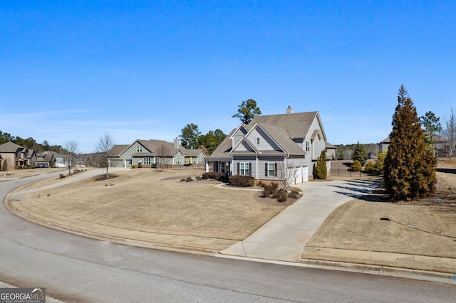 view of front of house featuring driveway, an attached garage, and a residential view