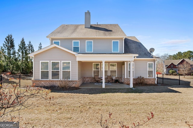 back of house featuring a patio area, fence, and brick siding