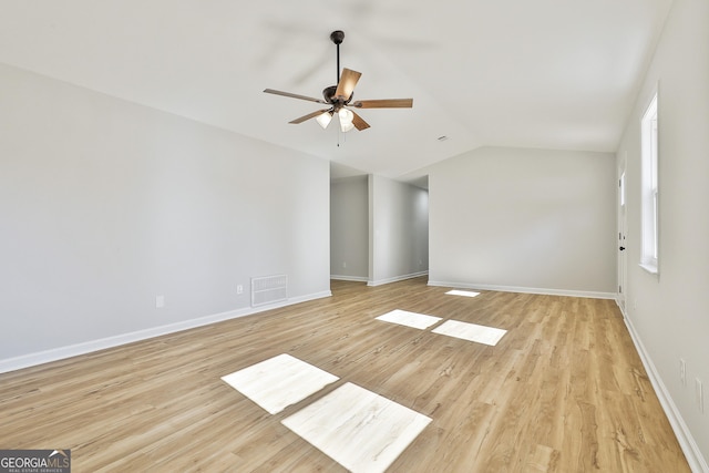 empty room featuring lofted ceiling, ceiling fan, and light hardwood / wood-style flooring