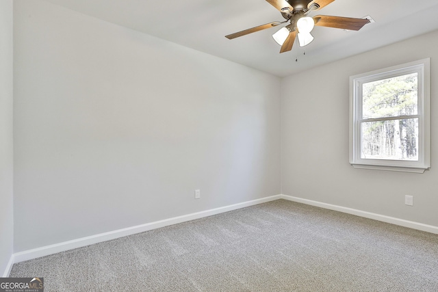 carpeted empty room featuring ceiling fan