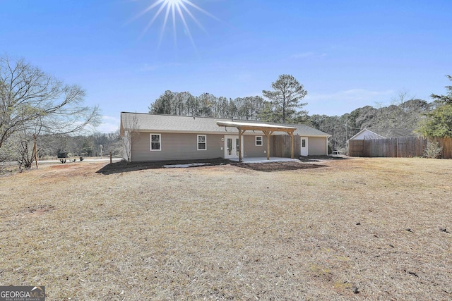 view of front of property with a front lawn and french doors