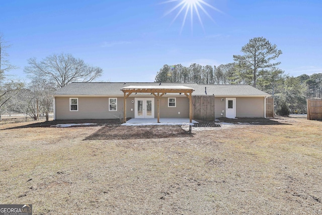 back of property featuring a lawn, french doors, and a patio area