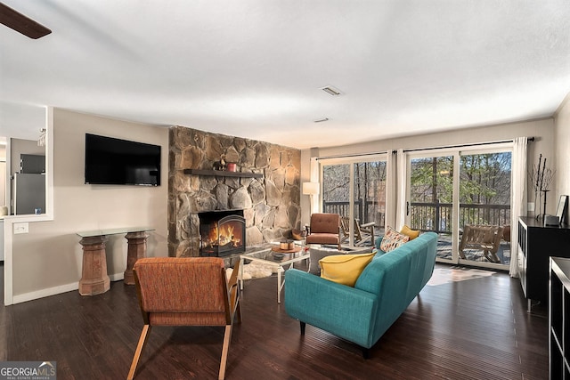 living room with dark hardwood / wood-style flooring and a fireplace