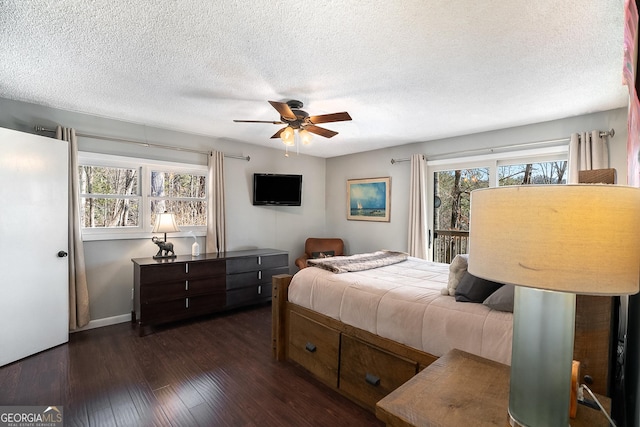 bedroom featuring a textured ceiling, ceiling fan, and dark hardwood / wood-style flooring