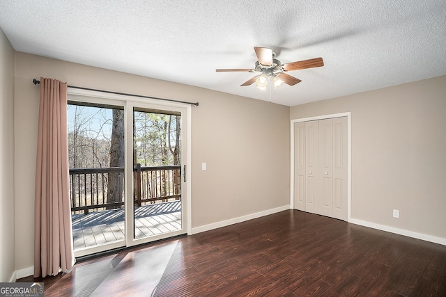 unfurnished bedroom with ceiling fan, access to outside, a closet, dark hardwood / wood-style flooring, and a textured ceiling