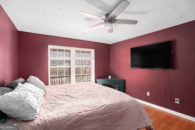905 Hancock Mountain Trl, Waleska, GA 30183 - bedroom featuring baseboards, ceiling fan, a textured ceiling, and wood finished floors