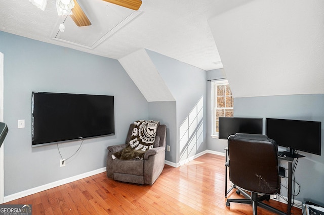 office space with vaulted ceiling, ceiling fan, and hardwood / wood-style floors