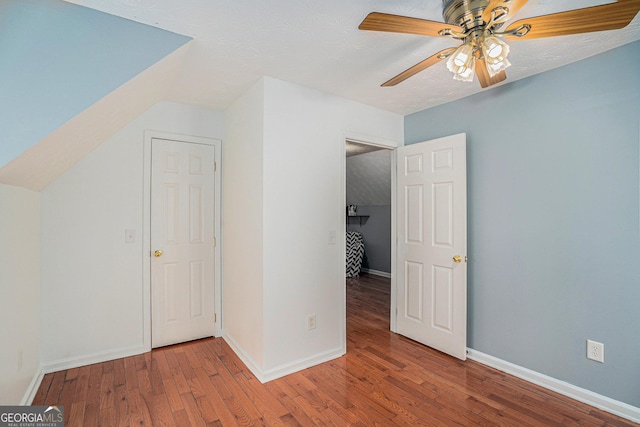 bonus room with ceiling fan and wood-type flooring