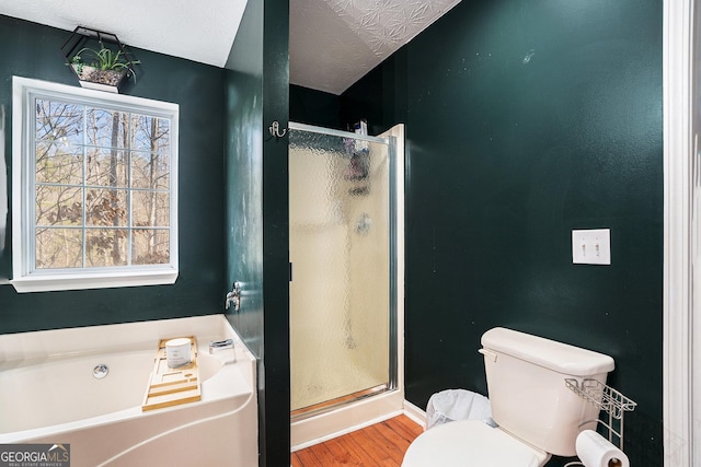 bathroom featuring plenty of natural light, toilet, independent shower and bath, and wood-type flooring