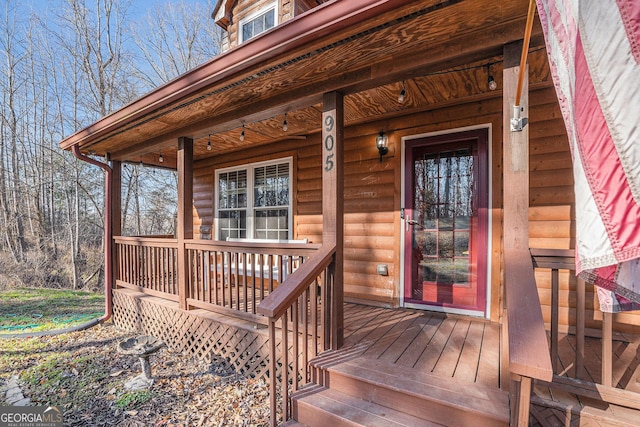 wooden terrace featuring covered porch