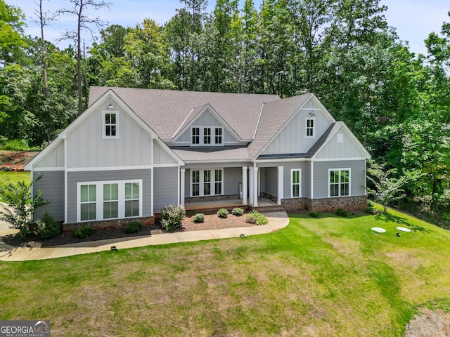 view of front of property with covered porch and a front yard