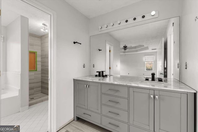 bathroom with ceiling fan, walk in shower, and vanity