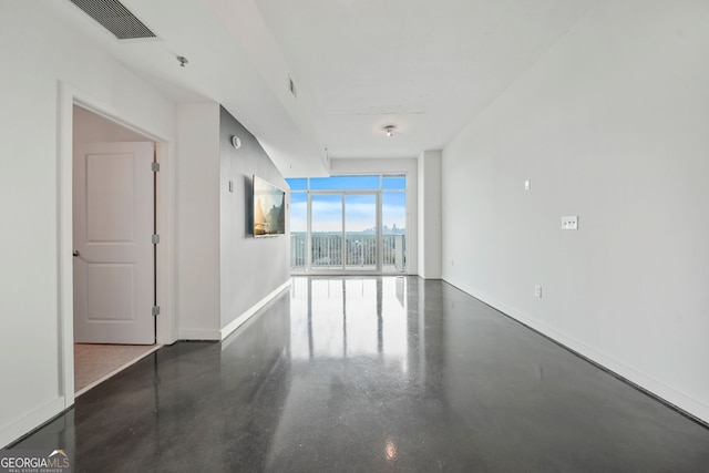 unfurnished room featuring floor to ceiling windows