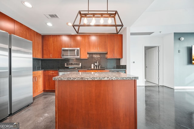 kitchen featuring appliances with stainless steel finishes, pendant lighting, tasteful backsplash, and a center island