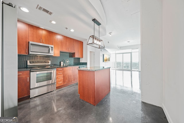 kitchen with appliances with stainless steel finishes, a center island, tasteful backsplash, sink, and hanging light fixtures