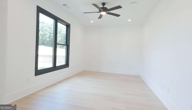 spare room featuring light wood-type flooring and ceiling fan